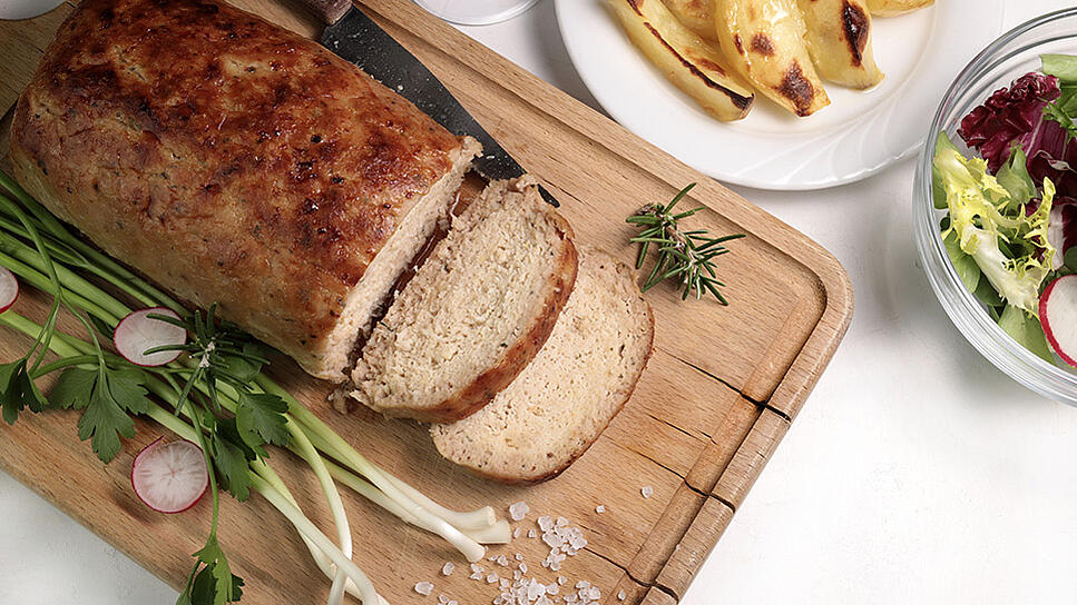 A wooden platter with Italian meatloaf