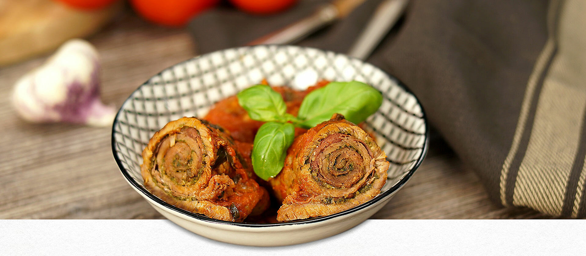 Ein Teller mit italienischen Kalbsrouladen in Tomatensauce